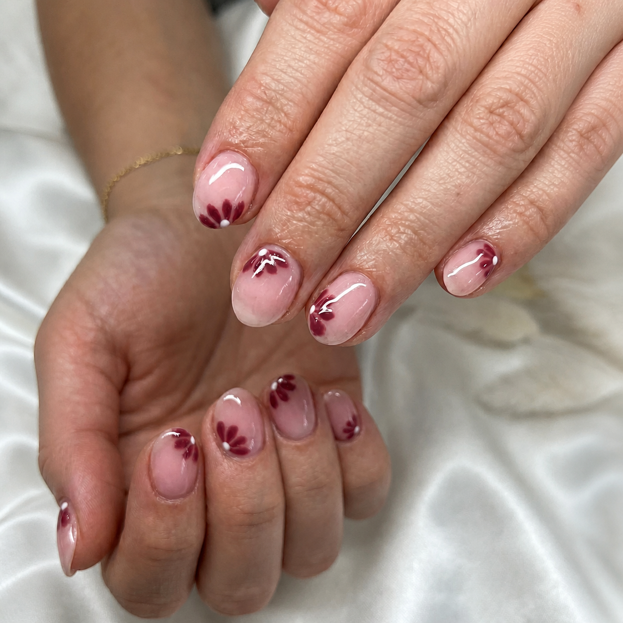 Short pink manicure with burgundy floral details