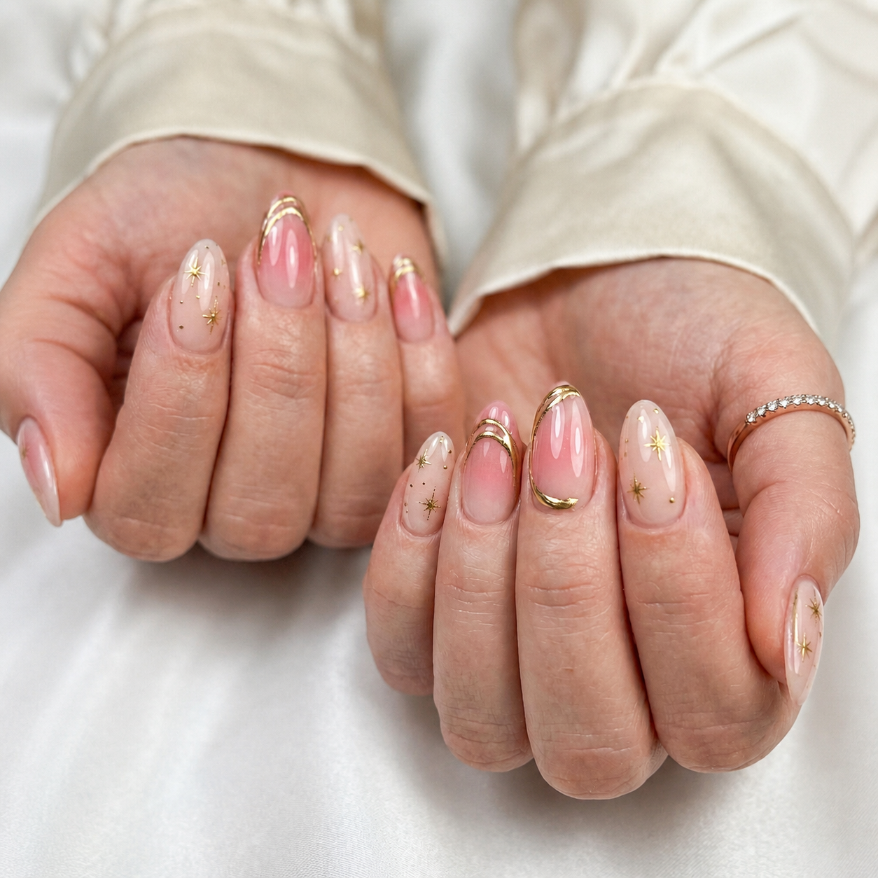 Pink almond manicure with fine gold details